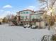 Two-story home with large deck, snowy backyard, and storage shed at 8932 Tuscany Ln, Highlands Ranch, CO 80130