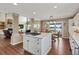 Open concept kitchen with island and view into living room at 8932 Tuscany Ln, Highlands Ranch, CO 80130