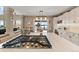 Kitchen island with cooktop and view to dining area and outside at 8932 Tuscany Ln, Highlands Ranch, CO 80130