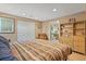 Spacious main bedroom with striped bedding and built-in shelving at 8932 Tuscany Ln, Highlands Ranch, CO 80130