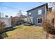 Inviting backyard featuring a spacious lawn, gray wood deck with outdoor seating, and gray shingle exterior at 728 N Ogden St, Denver, CO 80218