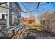 Private backyard showcasing a wood deck with seating, bordered by trees and mature landscaping offering relaxation and privacy at 728 N Ogden St, Denver, CO 80218
