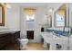 Classic bathroom with dual sinks, a vintage style cabinet, mirrors and a walk-in shower at 728 N Ogden St, Denver, CO 80218
