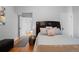 Bright bedroom with a comfortable bed, side table, and doorway leading to another room at 728 N Ogden St, Denver, CO 80218