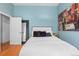 Stylish bedroom with an accent wall, large mirror, and comfortable bedding at 728 N Ogden St, Denver, CO 80218