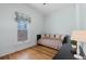 Cozy bedroom featuring hardwood floors, daybed, and a window offering natural light and outdoor views at 728 N Ogden St, Denver, CO 80218