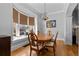 Formal dining room featuring hardwood floors, a decorative chandelier, and a large bay window at 728 N Ogden St, Denver, CO 80218