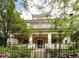 Beautiful two-story home with a large front porch and wrought iron fence at 728 N Ogden St, Denver, CO 80218