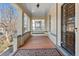 Inviting front porch with a swing, complemented by wood flooring and a decorative wrought-iron door at 728 N Ogden St, Denver, CO 80218