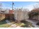 Private, detached garage with a concrete driveway, complemented by a wood fence, and landscaping at 728 N Ogden St, Denver, CO 80218