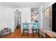 Open-concept seating area with window into adjacent kitchen, hardwood floors and white painted brick at 728 N Ogden St, Denver, CO 80218