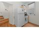 Compact kitchen near a staircase features white appliances and wood floors at 728 N Ogden St, Denver, CO 80218