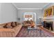 Comfortable living room with a fireplace, sofas, and glass coffee table, perfect for relaxing and entertaining guests at 728 N Ogden St, Denver, CO 80218