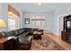 Comfortable living room with leather sectional, wood floors, and a large window, perfect for relaxation and entertaining at 728 N Ogden St, Denver, CO 80218