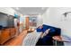 Comfortable living room featuring a blue couch, hardwood floors, and access to the backyard at 728 N Ogden St, Denver, CO 80218