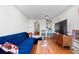 Bright living room features hardwood floors, a modern television, and a stylish blue velvet couch at 728 N Ogden St, Denver, CO 80218