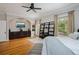 Main bedroom featuring hardwood floors, a ceiling fan, and decorative furniture at 728 N Ogden St, Denver, CO 80218