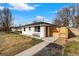 Charming exterior view of a white painted home featuring a well maintained lawn and a modern privacy fence at 3437 N Jackson St, Denver, CO 80205