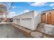 Spacious three-car garage with white doors and brick exterior, offering ample parking at 3437 N Jackson St, Denver, CO 80205