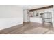 Spacious living area with luxury vinyl plank floors and a view into the kitchen with quartz countertops at 3437 N Jackson St, Denver, CO 80205