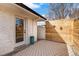 Outdoor patio with a gray patterned rug and a modern, light-colored wood fence at 3437 N Jackson St, Denver, CO 80205