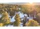 Aerial view of a secluded home partially covered in snow and surrounded by towering pine trees at 1220 Scarsbrook Ct, Monument, CO 80132