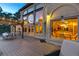 Stunning back deck at twilight features ample outdoor seating, dining area, and full view of interior rooms at 1220 Scarsbrook Ct, Monument, CO 80132