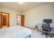 Cozy bedroom featuring a desk and an ensuite bathroom, providing a comfortable and private retreat at 1220 Scarsbrook Ct, Monument, CO 80132