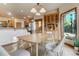 Inviting dining space with natural wood accents, large windows, and stylish lighting at 1220 Scarsbrook Ct, Monument, CO 80132