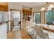 Cozy dining room featuring hardwood floors, built-in storage, and access to the laundry room at 1220 Scarsbrook Ct, Monument, CO 80132