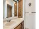 Bathroom featuring a single sink vanity and a large mirror, plus shower and built-in medicine cabinet at 438 N 11Th Ave, Brighton, CO 80601