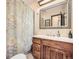 Bathroom featuring a light wood vanity, large mirror, and shower with patterned curtain at 438 N 11Th Ave, Brighton, CO 80601