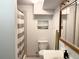 Bathroom featuring a toilet, sink, vanity mirror, towel rack, and shower with a white and gray striped curtain at 438 N 11Th Ave, Brighton, CO 80601