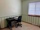 Bedroom features a black desk and large window for natural light at 438 N 11Th Ave, Brighton, CO 80601