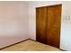 This bedroom features sliding closet doors for optimal storage at 438 N 11Th Ave, Brighton, CO 80601