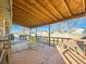 Covered outdoor deck with wooden flooring and railing, featuring a table and chairs at 438 N 11Th Ave, Brighton, CO 80601