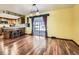 Bright dining area featuring hardwood floors, adjacent to the kitchen, with sliding glass doors to the backyard at 438 N 11Th Ave, Brighton, CO 80601