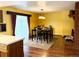 Elegant dining area with a wooden table, stylish chairs, and a cozy fireplace at 438 N 11Th Ave, Brighton, CO 80601