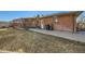 Exterior view of brick home featuring a covered deck and side yard at 438 N 11Th Ave, Brighton, CO 80601