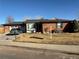 Charming brick home with a well-maintained front yard and a driveway leading to an attached garage at 438 N 11Th Ave, Brighton, CO 80601