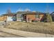 Charming red brick home with a well-maintained front yard and attached garage at 438 N 11Th Ave, Brighton, CO 80601