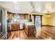 Bright kitchen featuring stainless steel appliances, wood cabinets, and hardwood floors at 438 N 11Th Ave, Brighton, CO 80601