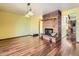 Spacious living area featuring hardwood floors, a brick fireplace, and bright lighting at 438 N 11Th Ave, Brighton, CO 80601