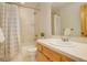 Bathroom with white tile, a shower and tub, and an attractive vanity at 31299 Manitoba Dr, Evergreen, CO 80439