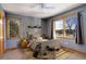 Bedroom featuring hardwood trim, windows, carpet, and modern furniture at 31299 Manitoba Dr, Evergreen, CO 80439