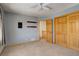 Carpeted bedroom with a ceiling fan and an adjacent staircase at 31299 Manitoba Dr, Evergreen, CO 80439