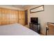 Cozy bedroom with wood closet, TV, and neutral tones at 31299 Manitoba Dr, Evergreen, CO 80439