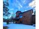 Exterior elevation showcasing a wooden home with a deck and windows reflecting the sky at 31299 Manitoba Dr, Evergreen, CO 80439