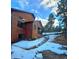 An exterior view of a beautiful wooden home featuring natural stone steps leading to the entrance at 31299 Manitoba Dr, Evergreen, CO 80439