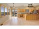 Open kitchen area featuring light wood cabinets, granite countertops, stainless steel appliances, hardwood floors, and outdoor access at 31299 Manitoba Dr, Evergreen, CO 80439